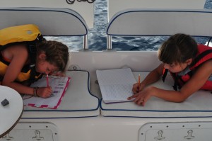 Reese and Kate writing stories together on the trip to Pigeon (aboard Anything Goes)