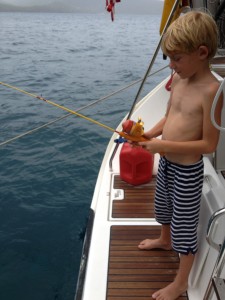 Porter fishes off the side of the boat.