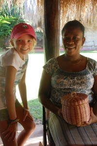 Reese talks to a fellow artist, a Carib basket weaver.