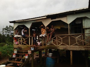 A family of farmers watch the unusual action past their farm, which lies in the middle of the Grenada hill country.