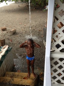 As we wait out a sudden downpour in Blue Bay, this little guy uses the runoff from the gutters to take a shower.  So cute!