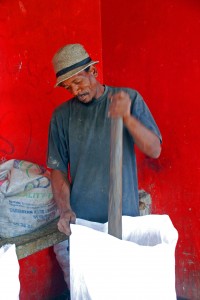 Dominican man making Copra, smoked coconut.