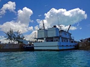 A Haitian boat and the Mail Boat block the entrance for hours so they can unload their goods.