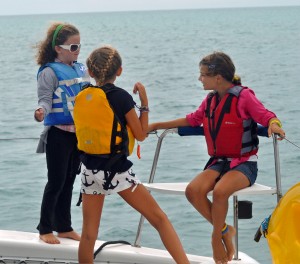 The girls hanging out of the bow of AG