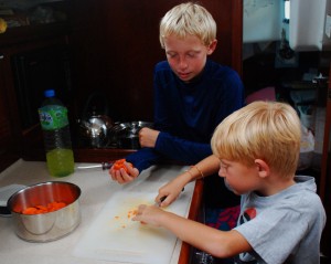 Bryson and Porter making dinner.  Working together as a family has become a joy and a source of pride for our children.